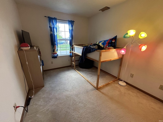 bedroom with carpet flooring and baseboards