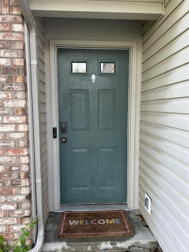 entrance to property with brick siding