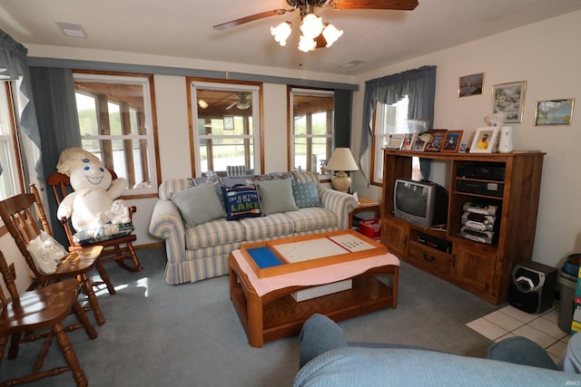 carpeted living area featuring visible vents and ceiling fan