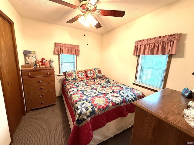carpeted bedroom featuring a ceiling fan and a closet