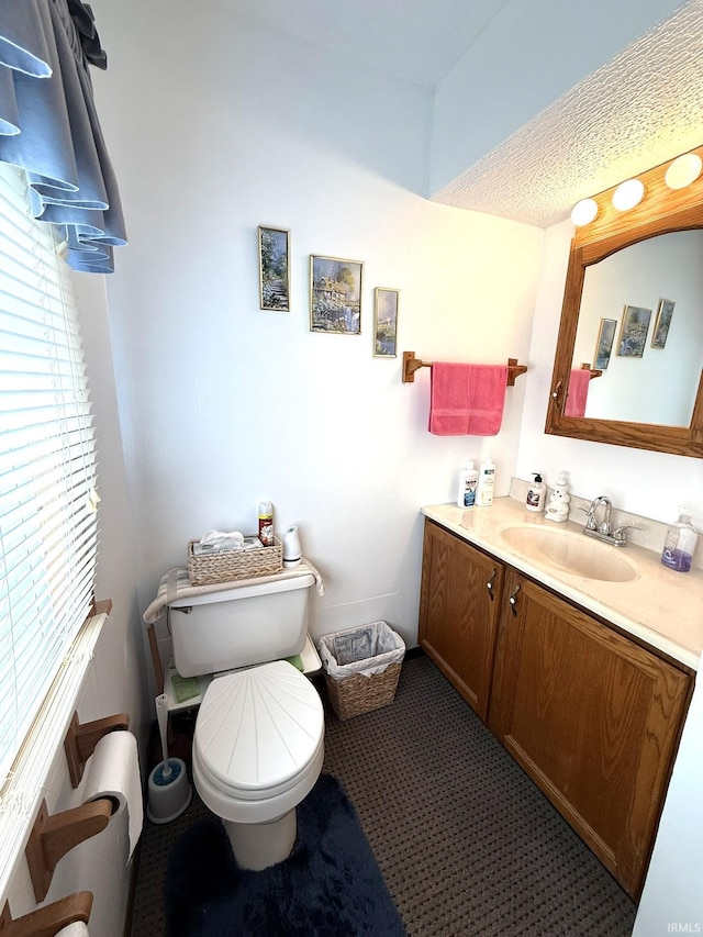 half bathroom featuring toilet and vanity