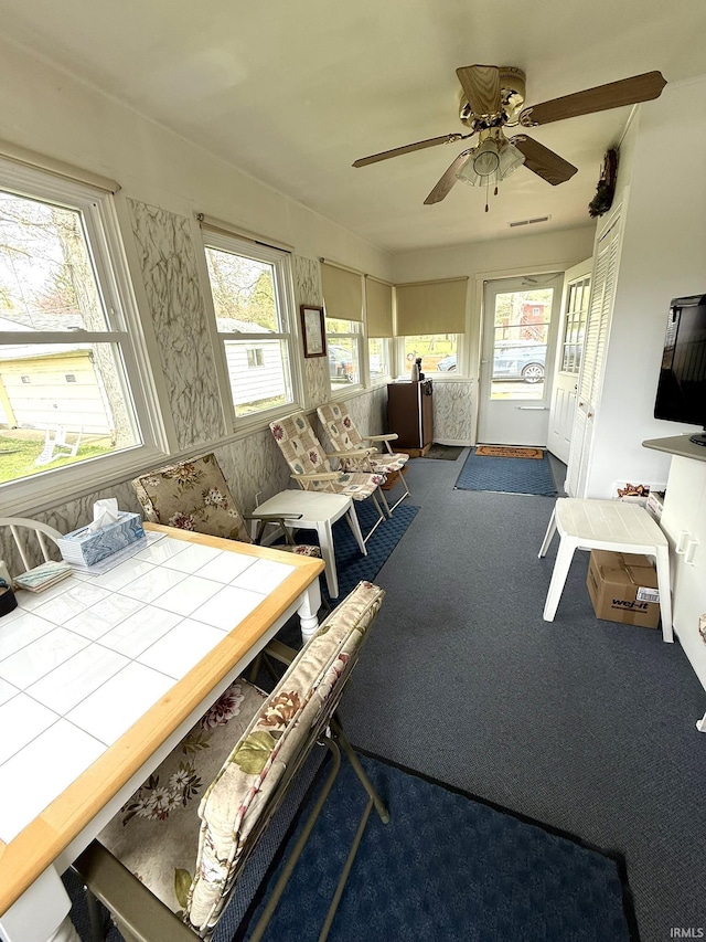sunroom featuring visible vents and a healthy amount of sunlight