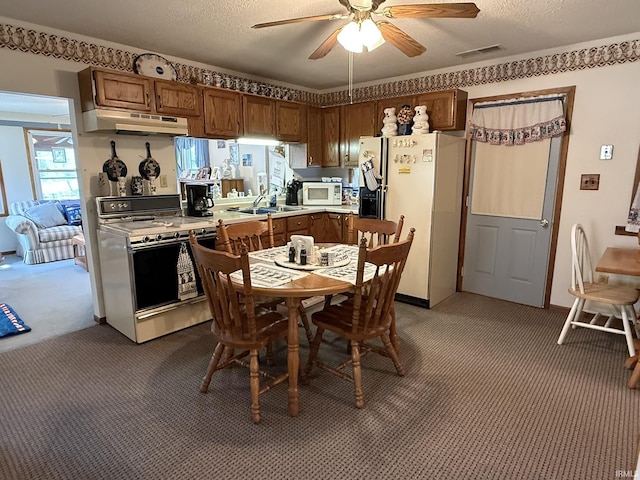 dining space featuring a textured ceiling, visible vents, ceiling fan, and carpet