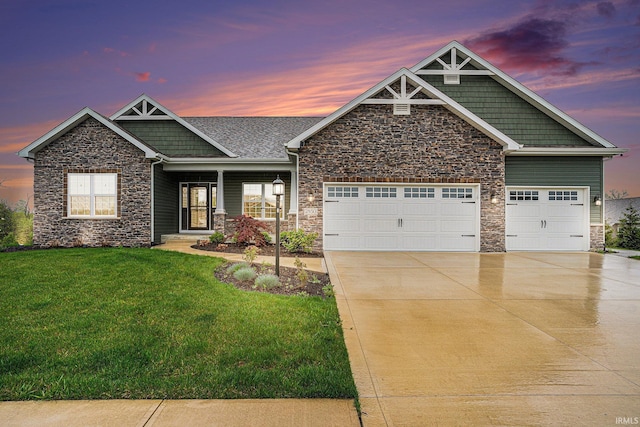 craftsman-style house with a garage, a front lawn, stone siding, and concrete driveway