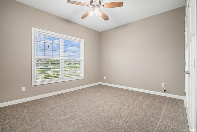 unfurnished room featuring carpet floors, baseboards, ceiling fan, and visible vents