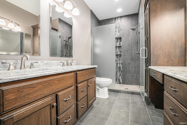 full bathroom with a stall shower, vanity, tile patterned floors, toilet, and recessed lighting