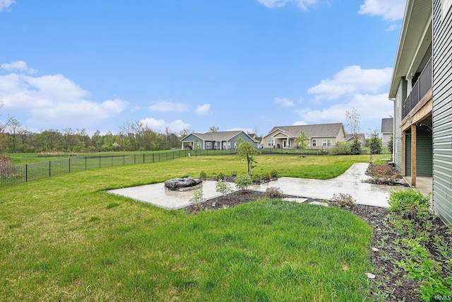 view of yard with a fenced backyard, a patio area, and an outdoor fire pit