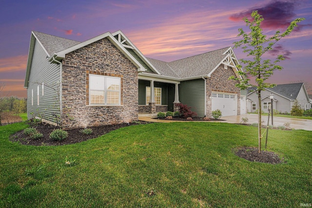 view of front of house with a garage, a front yard, stone siding, and concrete driveway