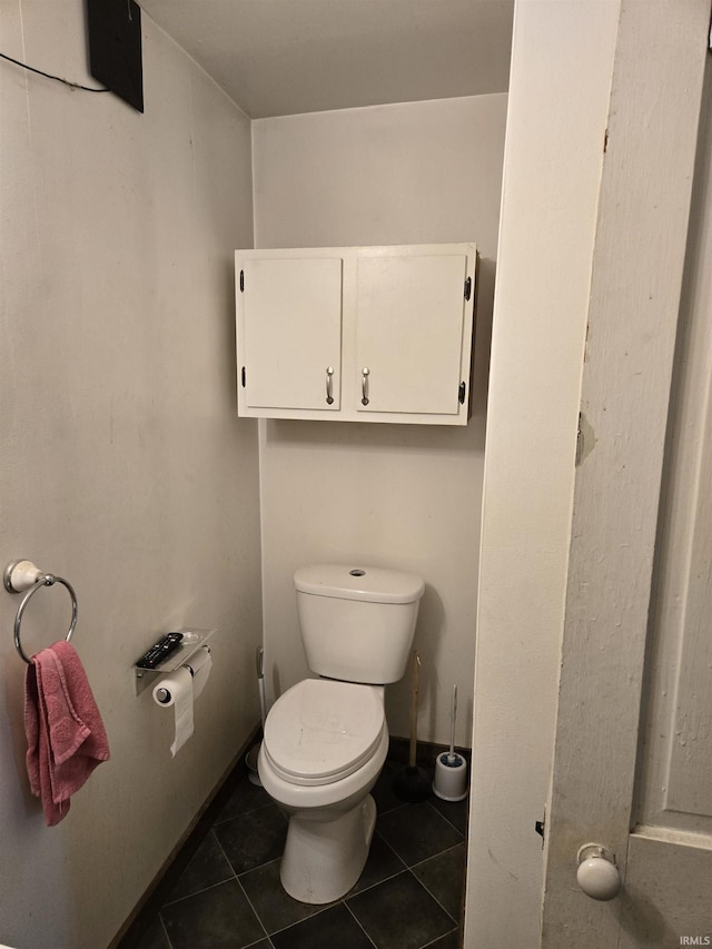 bathroom with toilet and tile patterned flooring