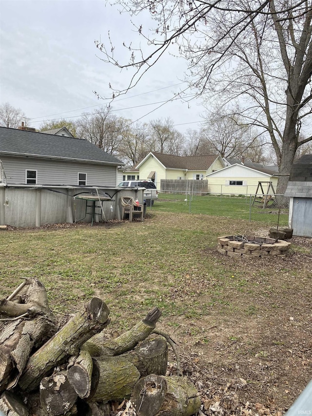 view of yard with fence and an outdoor pool