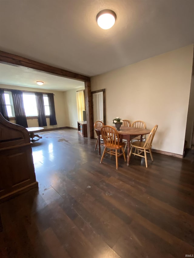 dining area featuring baseboards and wood finished floors