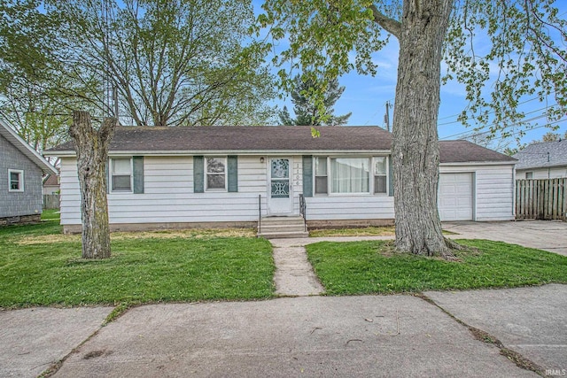 ranch-style house featuring concrete driveway, fence, a front yard, and a garage