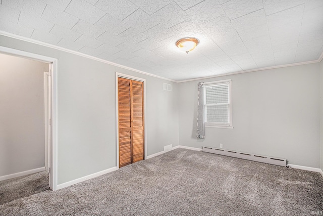 unfurnished bedroom with crown molding, baseboard heating, and carpet