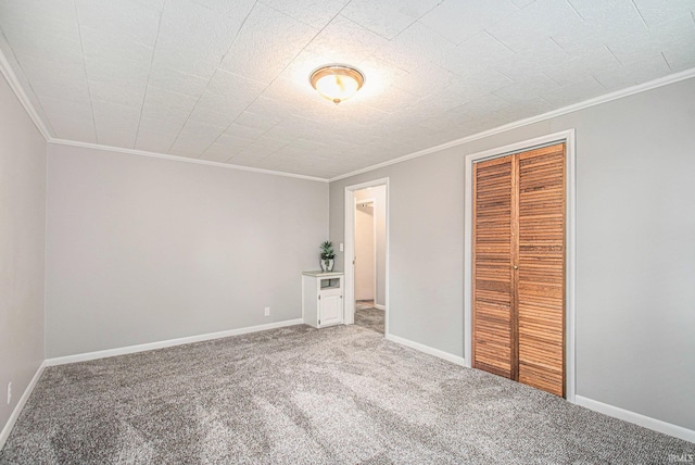 unfurnished bedroom with a closet, ornamental molding, and carpet