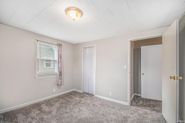 unfurnished bedroom with carpet and a closet