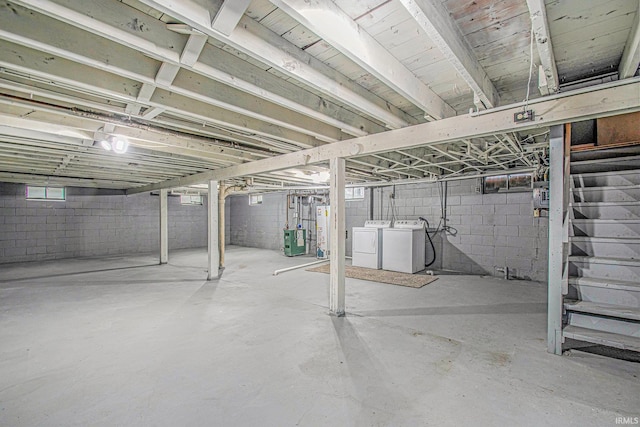 unfinished below grade area with independent washer and dryer, stairs, and water heater