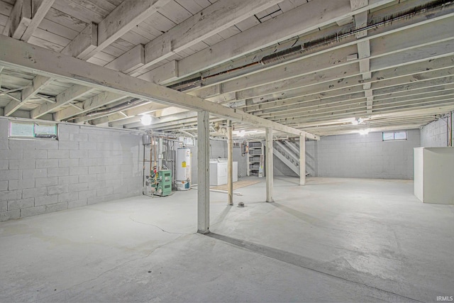 below grade area featuring gas water heater, stairs, and a heating unit