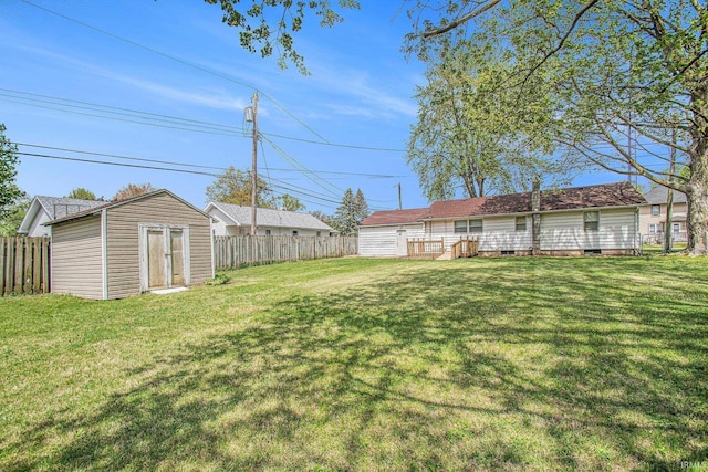 view of yard with a storage unit, an outdoor structure, and fence
