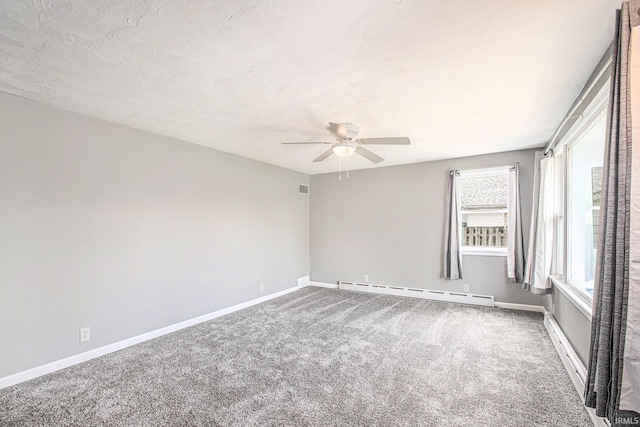 carpeted spare room featuring baseboards, a baseboard radiator, and a ceiling fan
