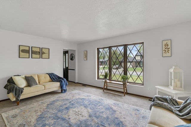 carpeted living room with a textured ceiling, baseboards, and visible vents