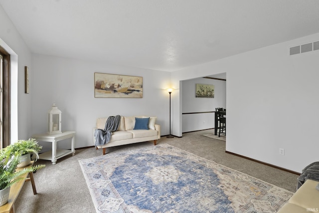 carpeted living room featuring baseboards and visible vents