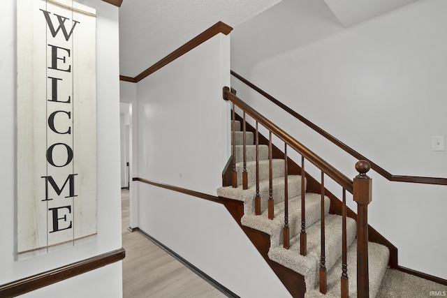 stairs featuring baseboards and wood finished floors