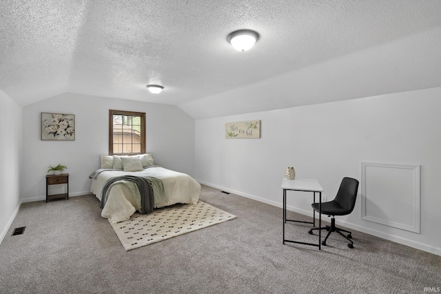carpeted bedroom featuring visible vents, baseboards, a textured ceiling, and lofted ceiling