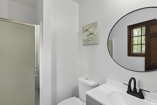 full bathroom with vanity, a stall shower, and toilet