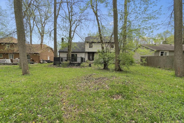 view of yard with fence and a deck