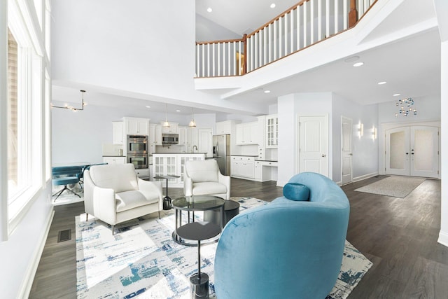 275 Ln 101 Hamilton Lk, Hamilton, IN 46742 - living area with visible vents, baseboards, dark wood-style floors, high vaulted ceiling, and french doors