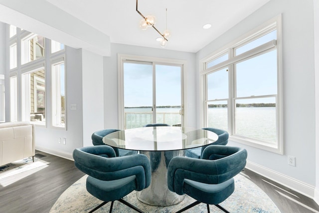 275 Ln 101 Hamilton Lk, Hamilton, IN 46742 - dining space with a water view, baseboards, a notable chandelier, and a healthy amount of sunlight