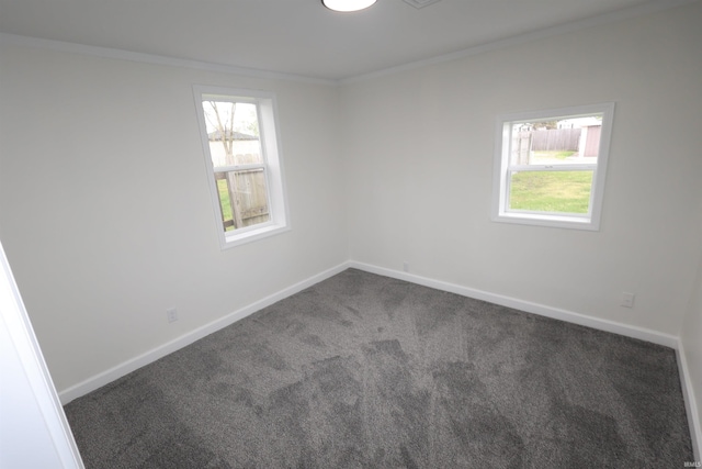 carpeted empty room with crown molding and baseboards