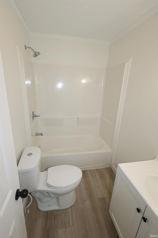 full bath featuring vanity, ornamental molding, wood finished floors, toilet, and  shower combination
