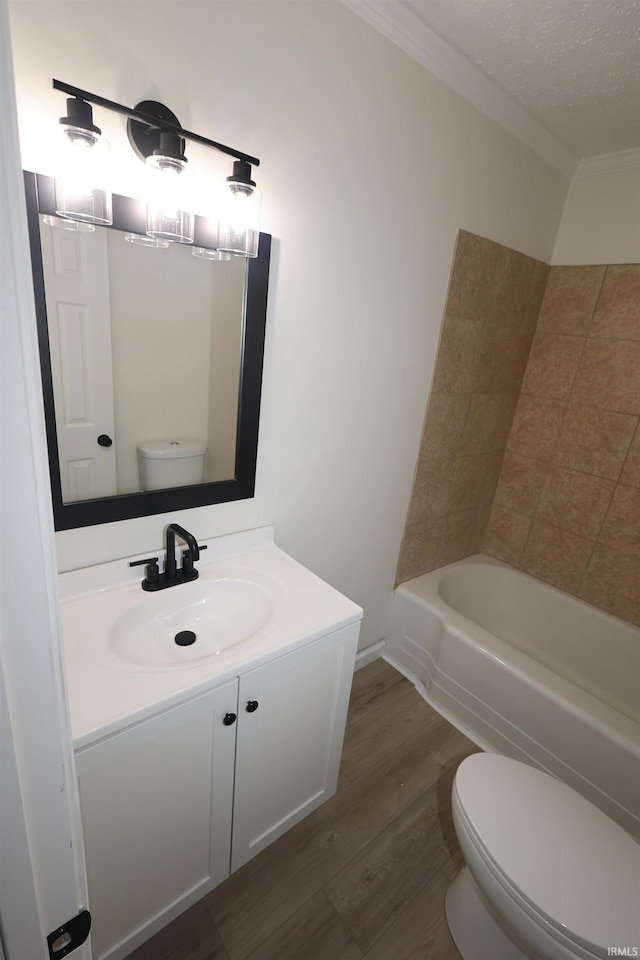 bathroom with crown molding, vanity, toilet, and wood finished floors