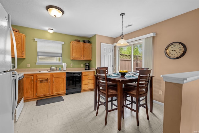 kitchen featuring a sink, light countertops, white appliances, and visible vents