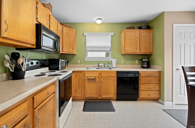 kitchen with a sink, light countertops, black appliances, and a toaster