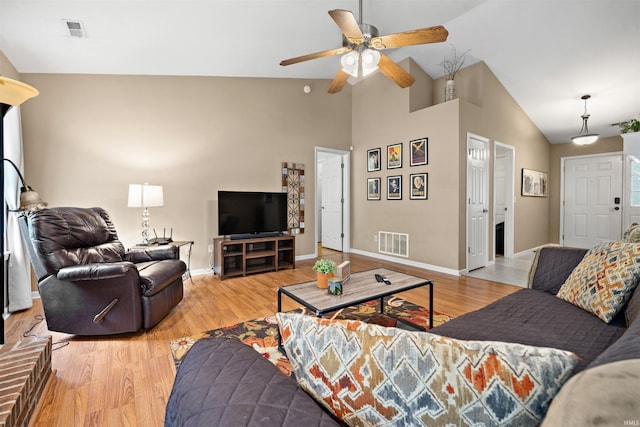 living area with ceiling fan, visible vents, and light wood finished floors