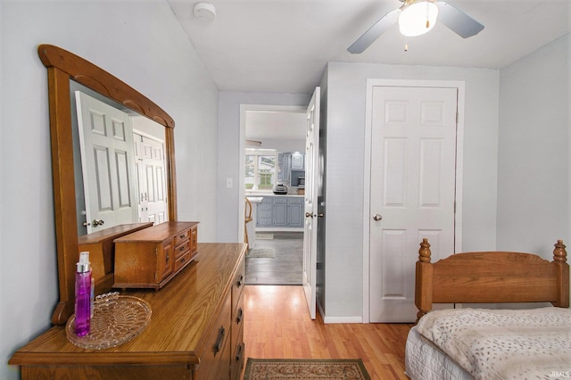 bedroom with light wood-style floors and a ceiling fan