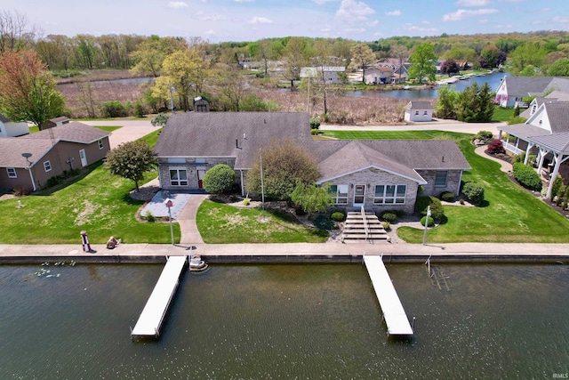 drone / aerial view with a residential view and a water view
