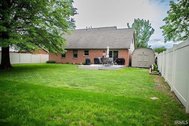 3701 Wethersfield Dr, Evansville, IN 47725 - rear view of house featuring a storage shed, brick siding, an outbuilding, a wooden deck, and a shingled roof