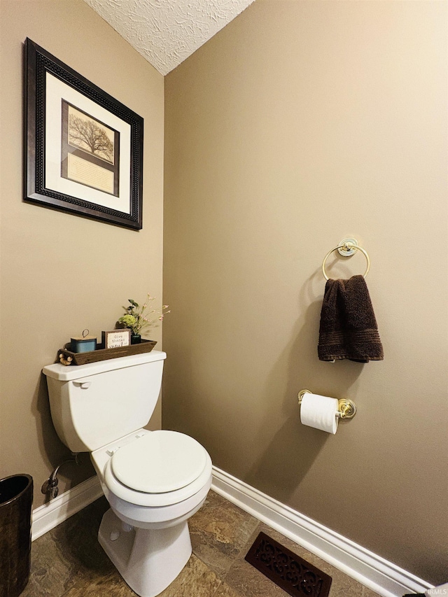 3701 Wethersfield Dr, Evansville, IN 47725 - bathroom with baseboards, toilet, and a textured ceiling