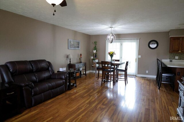 3701 Wethersfield Dr, Evansville, IN 47725 - dining room featuring baseboards, dark wood-style flooring, and a chandelier