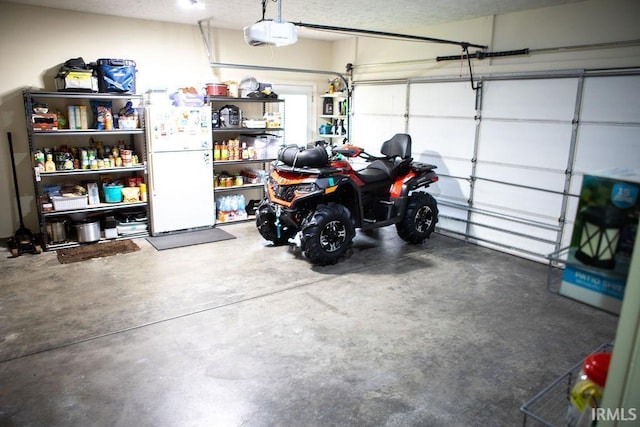 3701 Wethersfield Dr, Evansville, IN 47725 - garage with freestanding refrigerator and a garage door opener