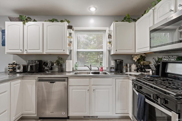 29930 Prairieview Farms Blvd, Elkhart, IN 46514 - kitchen featuring white cabinets, appliances with stainless steel finishes, a sink, and visible vents