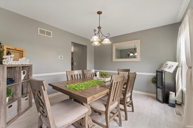 29930 Prairieview Farms Blvd, Elkhart, IN 46514 - dining room featuring baseboards, light wood finished floors, a chandelier, and visible vents