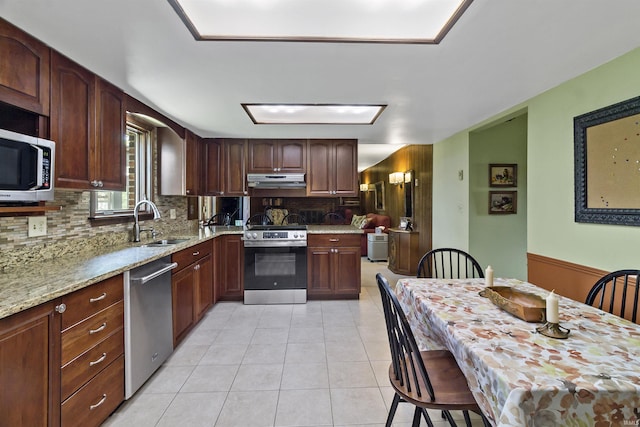 4231 N Conner Dr, Marion, IN 46952 - kitchen with light stone countertops, light tile patterned floors, a sink, appliances with stainless steel finishes, and backsplash
