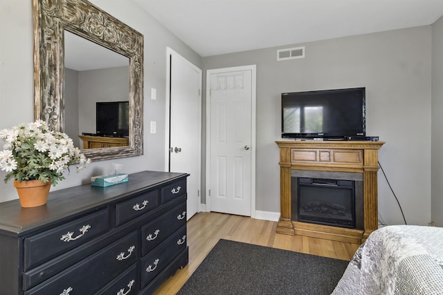 4231 N Conner Dr, Marion, IN 46952 - bedroom featuring visible vents, light wood finished floors, and a fireplace