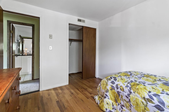 4231 N Conner Dr, Marion, IN 46952 - bedroom featuring visible vents, baseboards, wood finished floors, and a closet