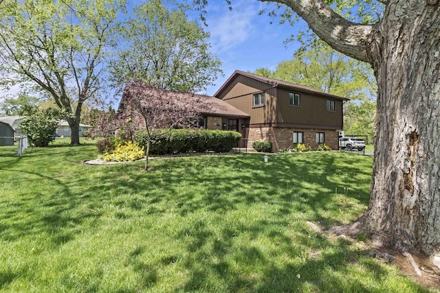 4231 N Conner Dr, Marion, IN 46952 - view of property exterior featuring a lawn and brick siding