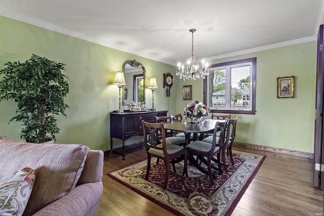 4231 N Conner Dr, Marion, IN 46952 - dining room with crown molding, baseboards, a notable chandelier, and wood finished floors